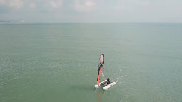 Man Sailing His Catamaran Sea Drone Pans Side Beautiful Coastal — Vídeos de Stock