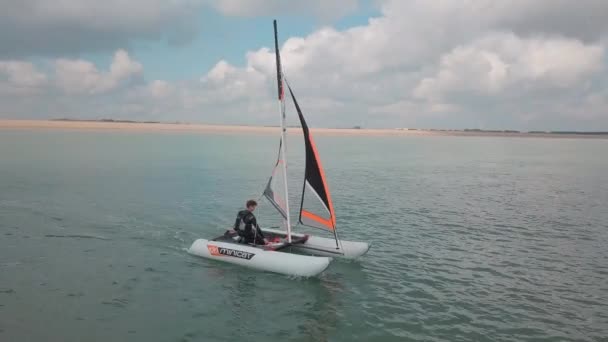 Man Sailing His Catamaran Sea Drone Pans Side Beautiful Coastal — Video