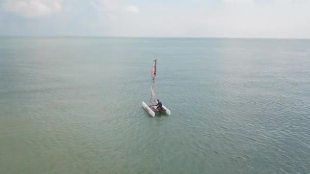 Man Sailing His Catamaran Sea Drone Flyover Looking Beautiful Coastal — стоковое видео