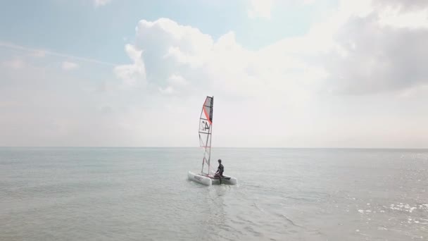 Man Sailing His Catamaran Sea Drone Follows Pans Out Side — Stok Video