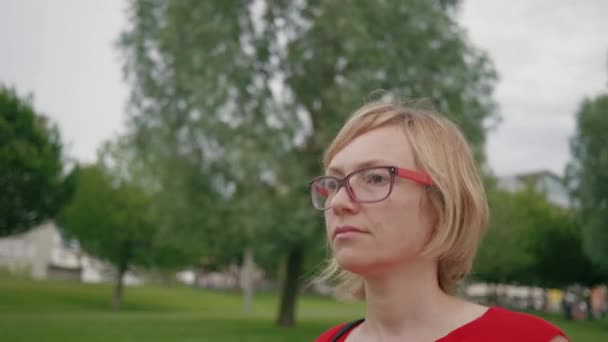 Follow Shot Blonde Caucasian Woman Wearing Glasses Red Dress Walking — Vídeo de stock