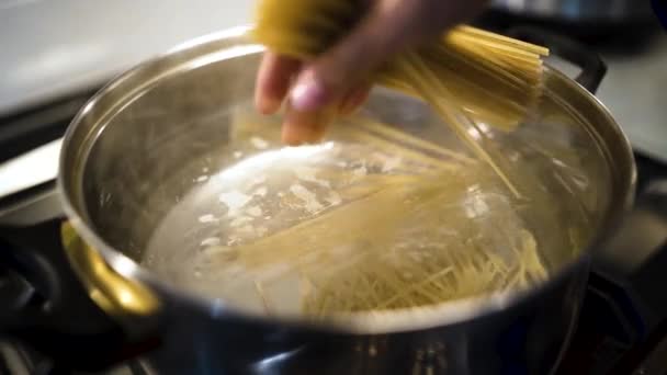 Chef Dropping Handful Spaghetti Noodles Pot Boiling Water Slow Motion — Vídeos de Stock