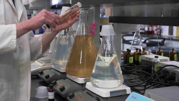 Scientist Lab Coat Mixing Chemicals Glass Bottle Lab — стоковое видео