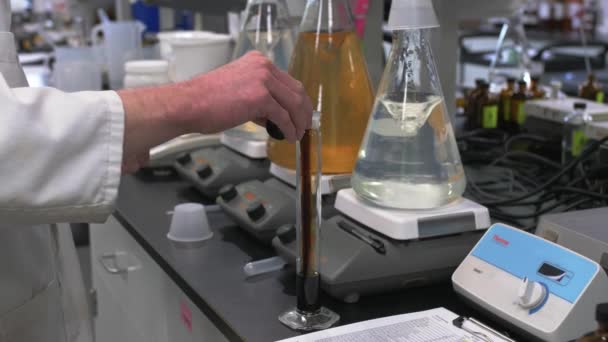 Scientist Lab Coat Mixing Chemicals Glass Bottle Lab — Stock Video