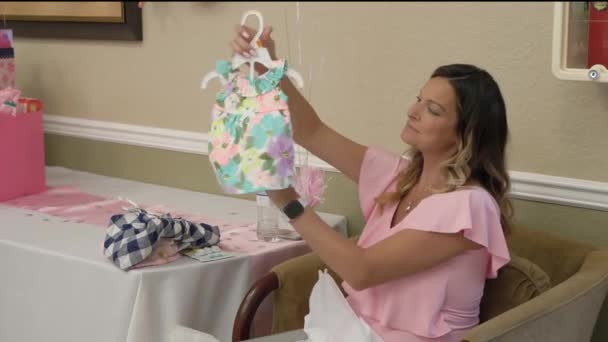 Expecting Mother Shows Her Baby Shower Gift — Stockvideo