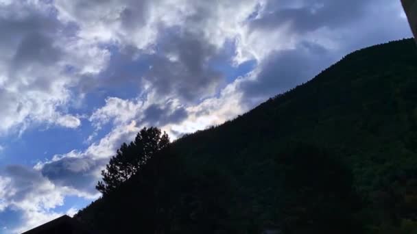 Footage Heavy Moving Clouds Mountain Trees Sunlight Background House Foreground — Stockvideo