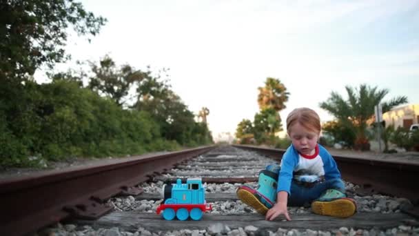 Young Child Has Great Time Playing Train Tracks Pretending Engineer — Stockvideo