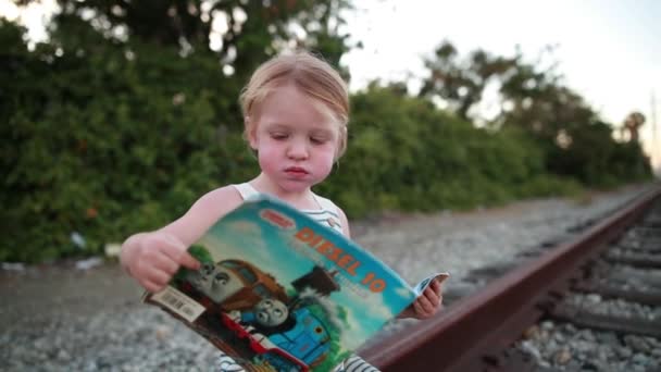 Young Child Has Great Time Reading Book His Train Train — Stockvideo