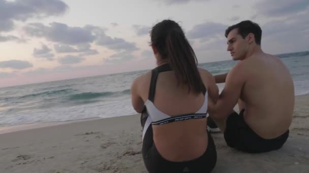 Relaxing Training Young Attractive Couple Sit Beach Sunset — Stockvideo