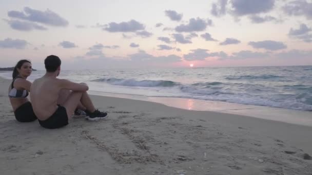 Young Fit Couple Resting Beach Training Sunset — Stockvideo