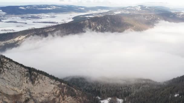 Aerial Low Hanging Clouds Snow Covered Mountain Pass — Stockvideo