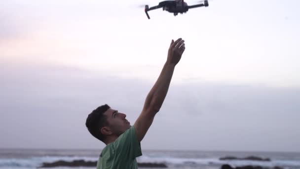 Man Stands Coast Raises His Arm Catches Modern Drone Right — Video Stock