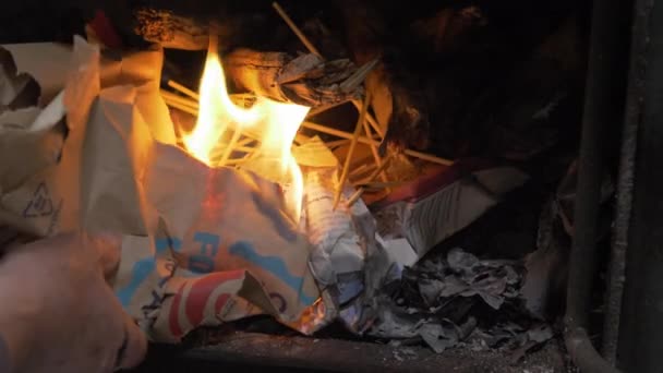 Male Hand Adding Burning Paper Wood Stove Close — Video Stock