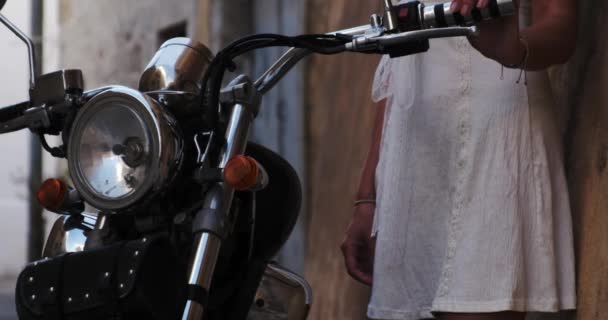 Beautiful Woman Wearing White Dress Holding Cool Motorcycle Handle Bars — Stock video