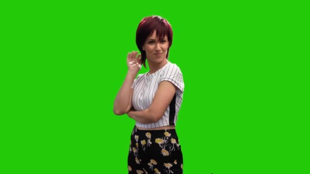 Cheerful Short Haired Brunette Female Adjusting Hair Green Screen — Wideo stockowe