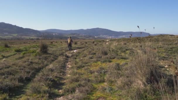 Man His Dog Walking Rough Path Open Field Small Group — Stockvideo