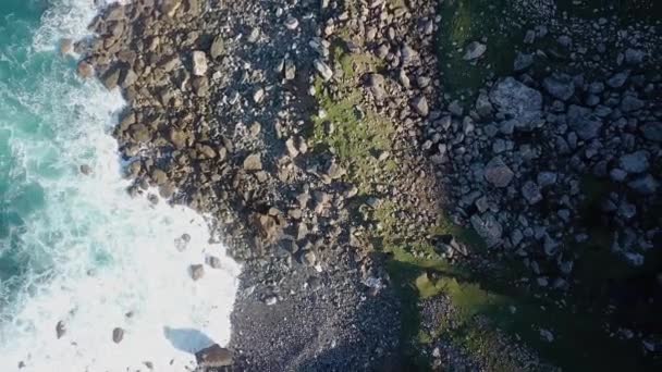 Aerial Overhead Shot Surf Breaking Wild Rocky Coast Sunny Day — Stockvideo