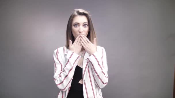 Surprised Petite Woman Covers Her Lips Hand Grey Background — Video Stock