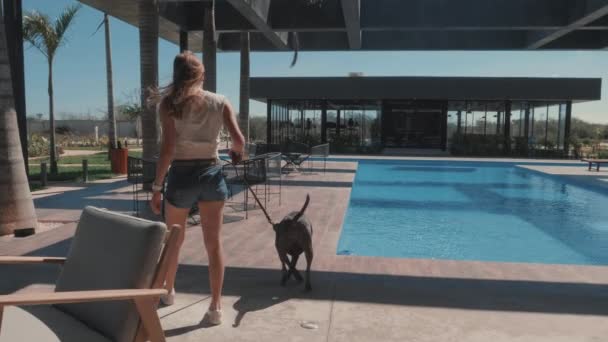 Young Woman Walking Her Dog Outdoor Pool Area Slow Motion — 图库视频影像