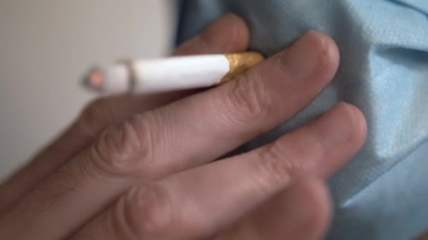 Close Man Smoking Cigarette Hole Face Mask — стоковое видео