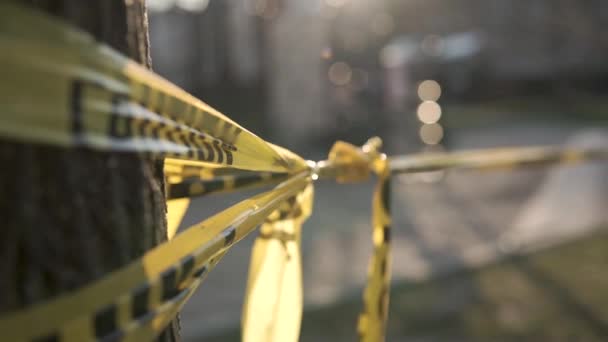 Yellow Caution Tape Foreground Closed Playground Background Blurred Out — Stockvideo