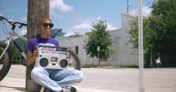 Panning Shot African American Female Holding Boom Box While Sitting — Stock video