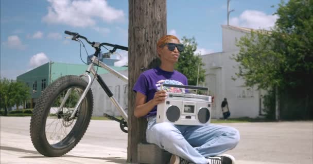 Panning Shot African American Female Holding Boom Box While Sitting — 비디오