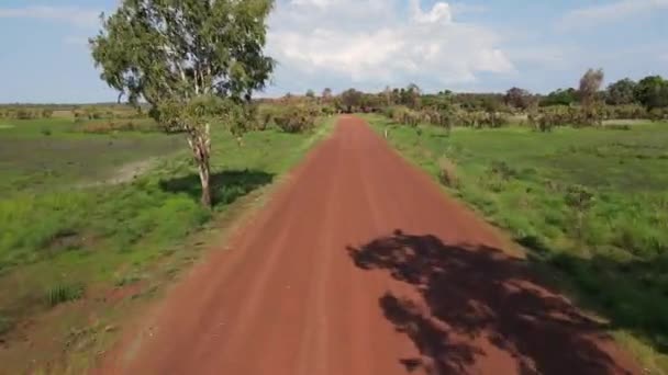 Low Fast Moving Drone Shot Red Road Moving Green Bushland — Wideo stockowe