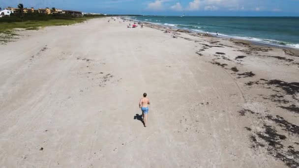 Young Adult Male Running Exercising Florida Beach Aerial — 비디오