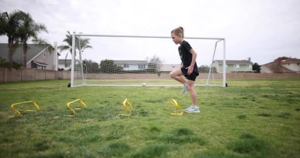 Young Girl Warming Practice Doing High Kees Set Speed Hurdles — Stockvideo