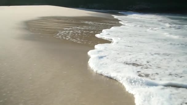 Pan Traking Some Waves Hitting Shore Beautiful Beach Golden Sand — Stockvideo