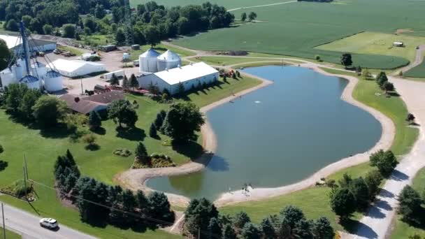 Quick Shot Farm Operation Overlooking Pond — Vídeos de Stock
