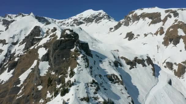 Aerial Snow Covered Rocky Mountain Top Ski Lifts Slope — Video Stock