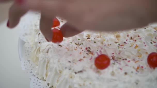 Caucasian Hand Putting Red Cherry Candy White Cream Cake Whit — Vídeo de stock