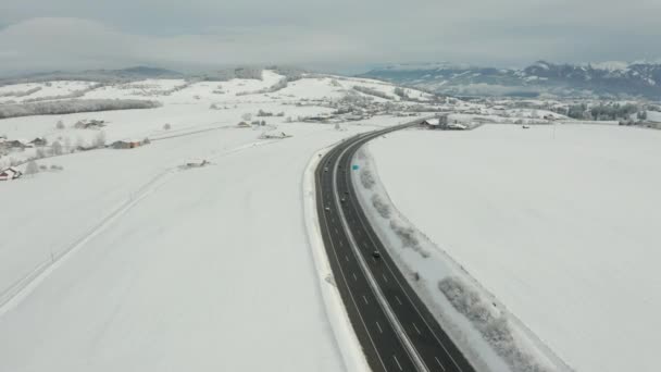 Aerial Busy Highway Running Snow Covered Rural Landscape — Wideo stockowe