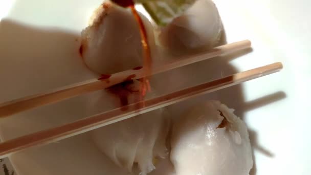 Small Bowl Few Dumplings Pair Chopsticks Sitting Top Some Soy — Videoclip de stoc