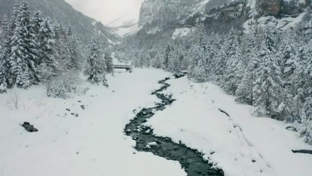 Aerial Small Creek Running Snow Covered Landscape Drone Slowly Lifting — Vídeos de Stock