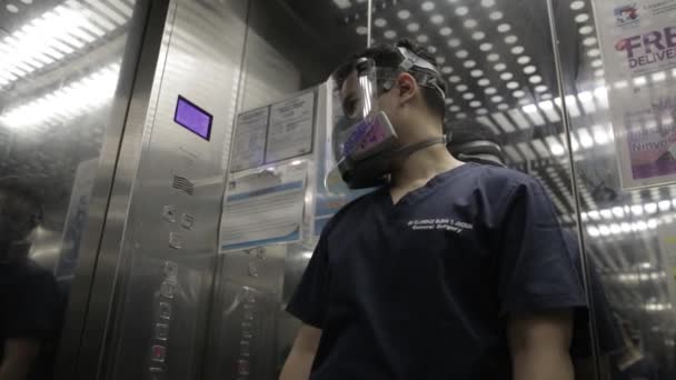 Doctor Wearing Respirator Face Shield Pushing Button Hospital Elevator — Stok video