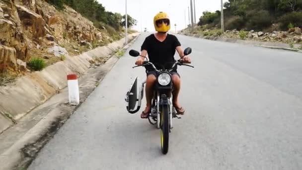 Young Male Motorcyclist Driving Road Vietnam Carrying Kitesurfing Board – stockvideo