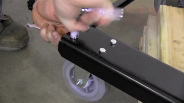 Installing Caster Wheel Metal Dolly Socket Wrench — Stock Video