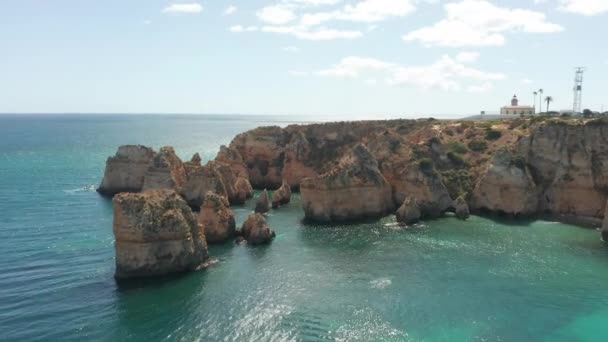 Drone Descending Eroded Cliffs Surrounded Blue Sea — Wideo stockowe