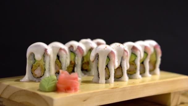 Sushi Roll Sauce Top Being Sprinkled Red Toppings Served Wooden — Stock video