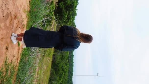 Girl Dressed Blue Looking Windmill Farm Absorbing Scenic View — Stockvideo