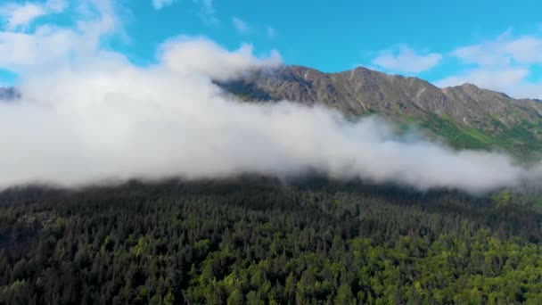 Drone Video Low Elevation Clouds Racing Steep Grassy Mountain Shore — Stock video