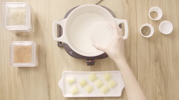Female Chef Pouring Milk Cooking Pot Electric Stove Top Shot — Vídeo de stock
