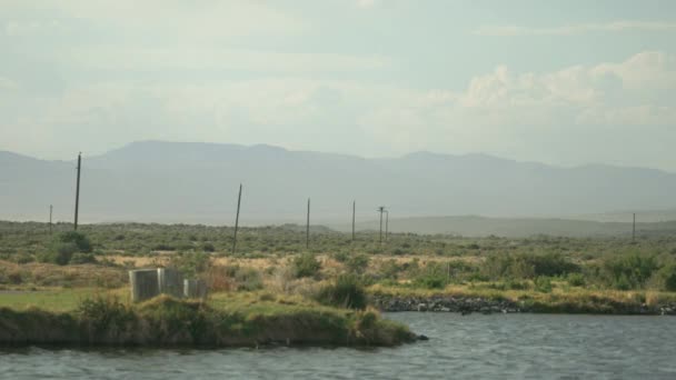 Peaceful Telephoto Footage Pond Telephone Poles Going Distance Large Clouds — Stock videók