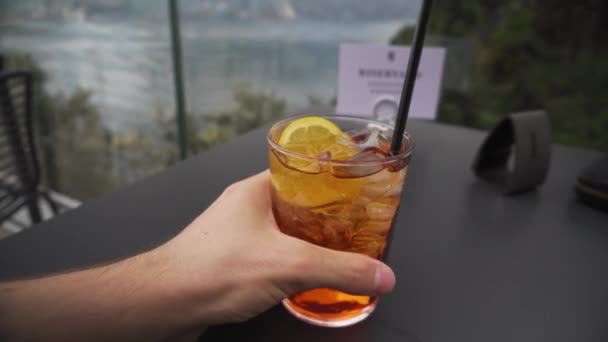 Man Rising Glass Aperol Spritz Table Restaurant Garda Lake Italy — Stockvideo