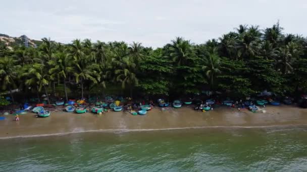 Aerial Dolly Left Shot Beach Scene People Coracle Boats Sand — Stockvideo