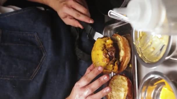 Chef Placing Burger Patty Melted Cheese Top Burger Bun Close — Video