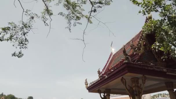 Static Shot Thai Temple Roof Shining Sun Tree Branches Swaying — Vídeo de Stock